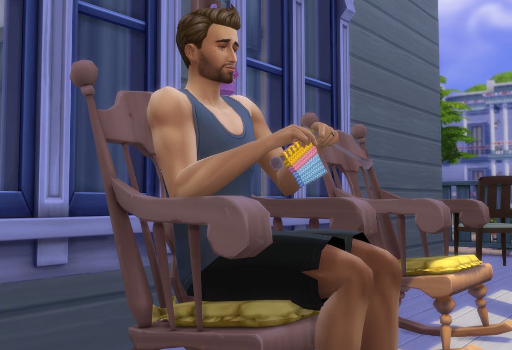 A Sim knits in a rocking chair in the Sims 4 Nifty Knitting Stuff Pack